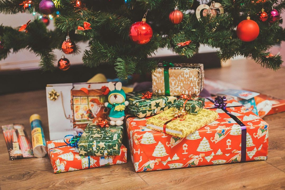 Wrapped presents under a decorated Christmas tree