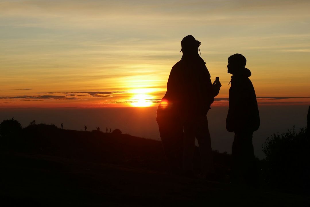 A parent and child together at sunset