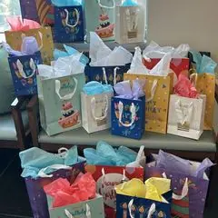 A pile of colorful birthday gift bags