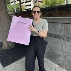A volunteer holding a birthday gift bag