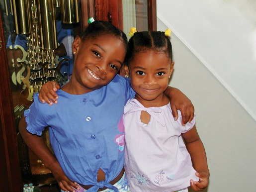 Young Simone and Adria Biles standing together